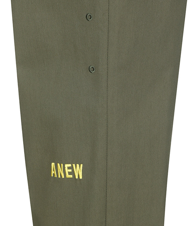 ANEW Golf Men Loose Fit Selvage Roll-Up Long Pants displayed on a hanger, showcasing the relaxed fit and stylish roll-up design.